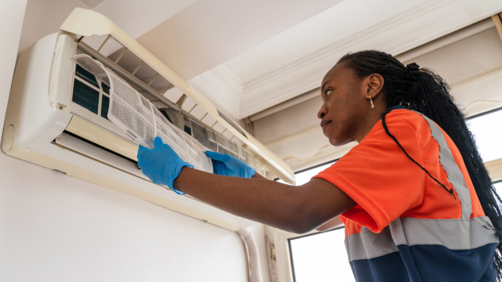 technician servicing air conditioner